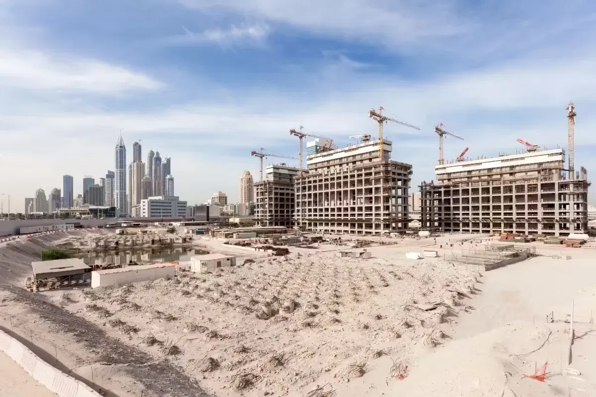 Land under development with construction cranes in Dubai